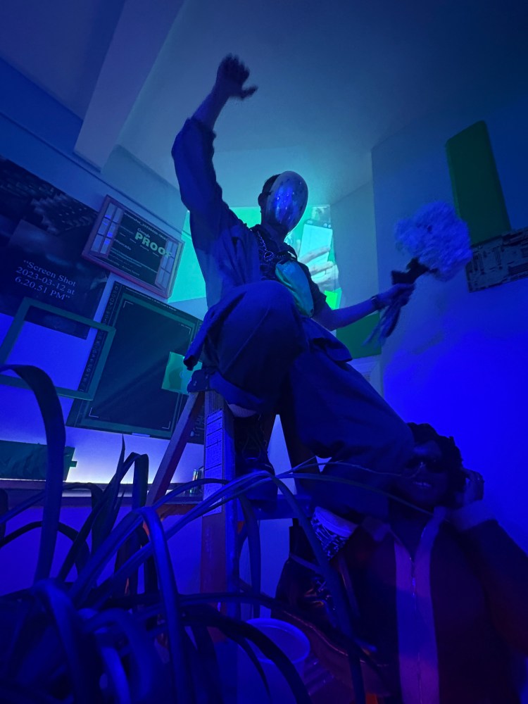 figure on a ladder in blue light